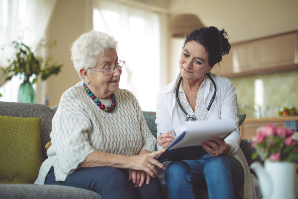 Social worker is visiting a senior woman